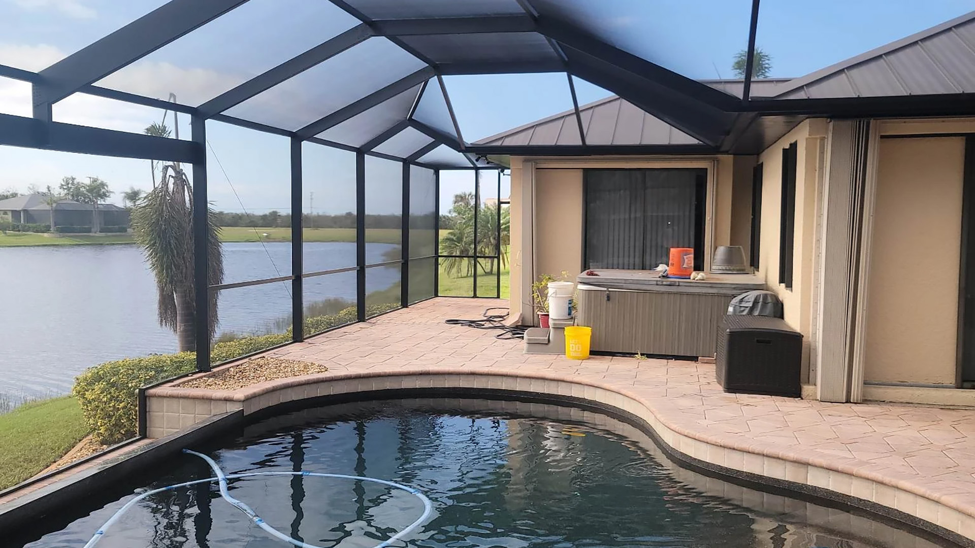 A patio enclosure covering a pool and hot tub. Taken in Cape Coral Florida